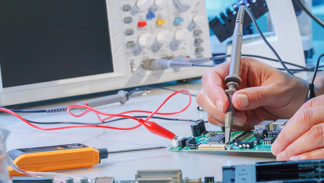 A biomedical engineer repairing a biomedical device PCB.