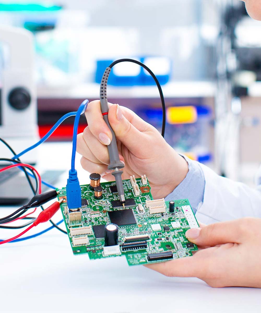 A Biomedical engineer repairing a PCB.