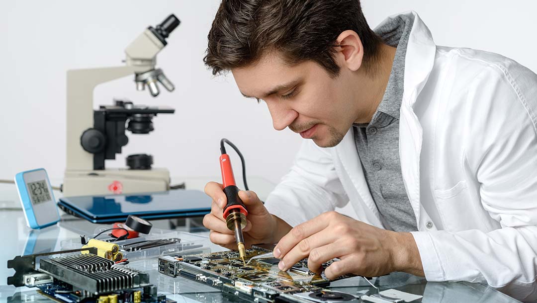 biomedical engineer repairing the part of an electronic device.