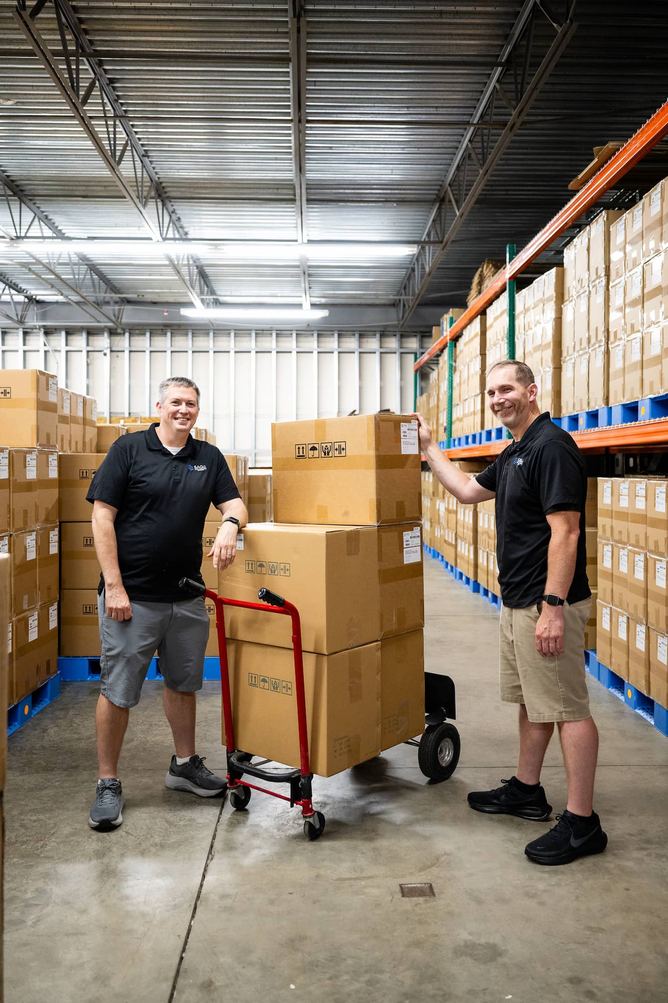 two smiling employees in the warehouse